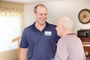 A caregiver with a resident at the Wolf Creek facility