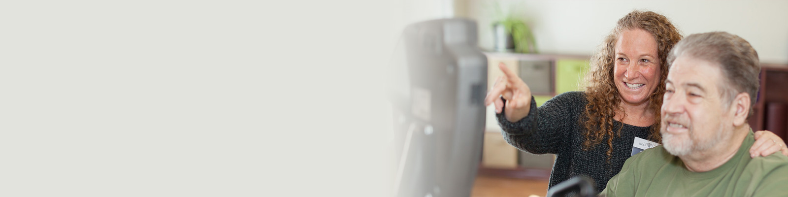 A Wolf Creek rehab therapist with a resident in the rehab gym